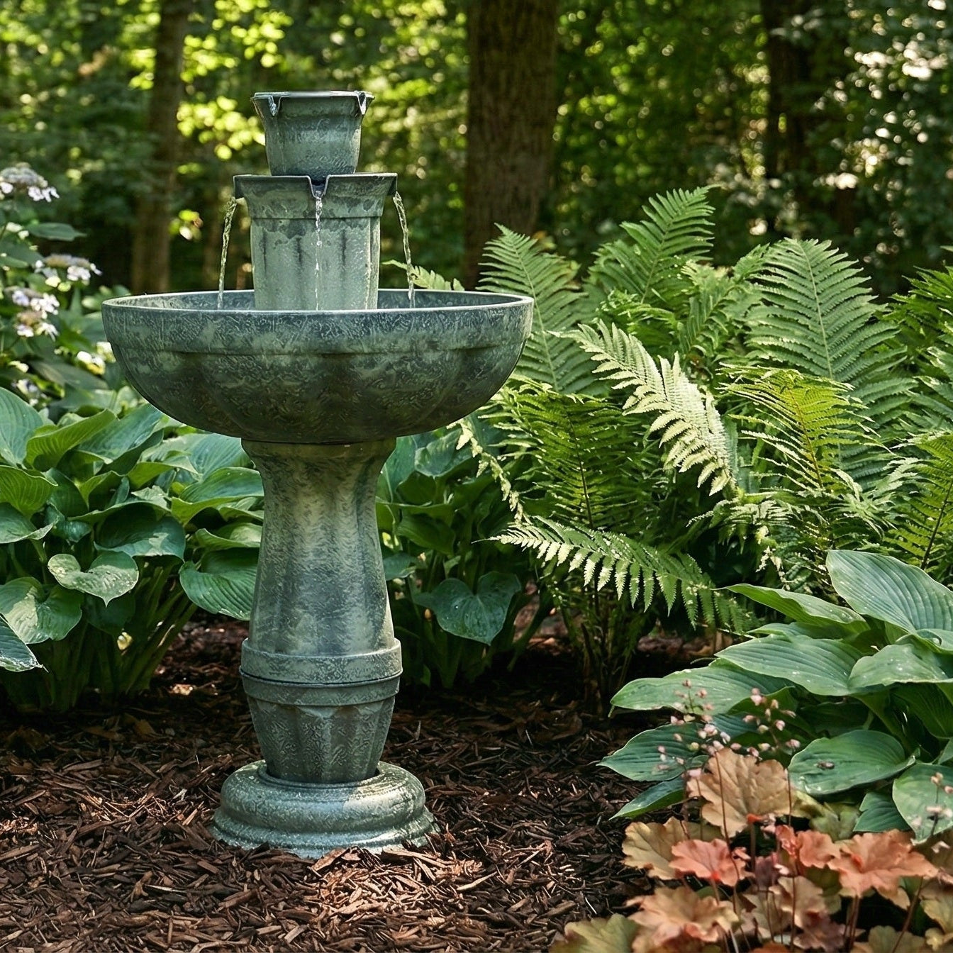 Decorative garden fountain surrounded by lush greenery in a forest setting