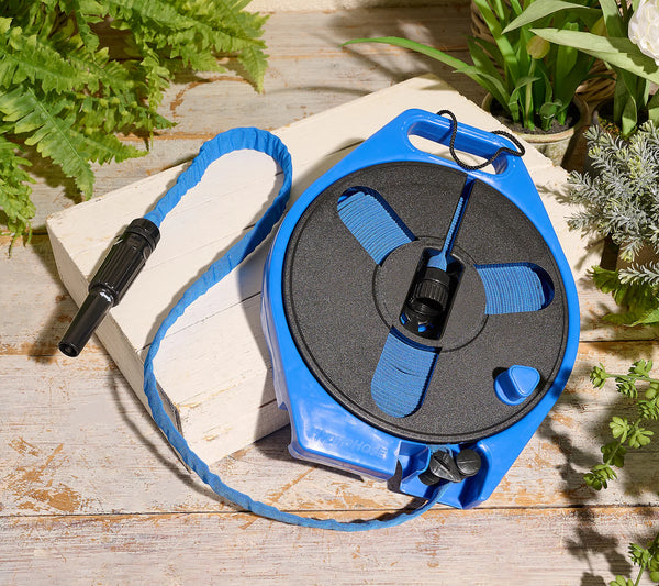 A 40' blue garden hose on a reel, placed on a wooden surface with greenery in the background.