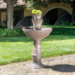 Decorative outdoor fountain with plants on a patio