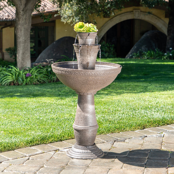 Decorative outdoor fountain with plants on a patio