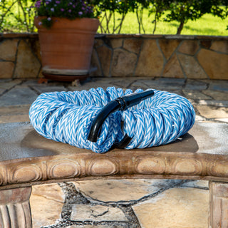 Blue and white striped hose on a stone surface outdoors