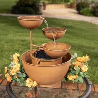 Bronze outdoor fountain with water feature on a patio