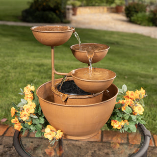 Bronze outdoor fountain with water feature on a patio