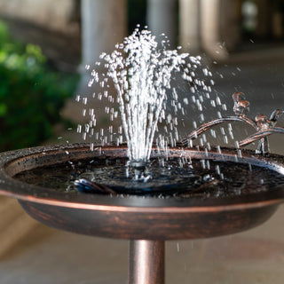 Small water fountain with decorative elements on a blurred background