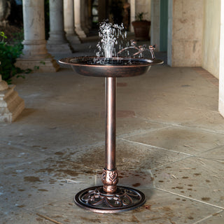 Bronze bird bath with water feature on a stone patio