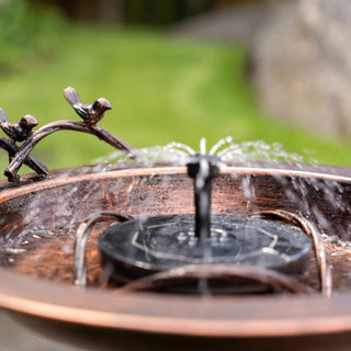 Decorative outdoor water fountain with birds on a branch
