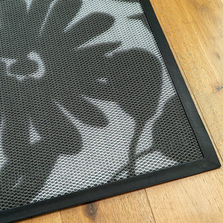 Black mesh mat on a wooden floor